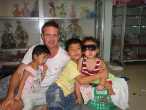 Tim with the orphans. One toddler is wearing Tim’s sunglasses. Cool, huh?