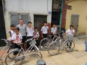 Some junior high school kids going to school by bicycle.