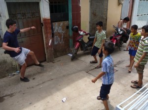 A student trying out Vietnamese traditional game, kick the feather.